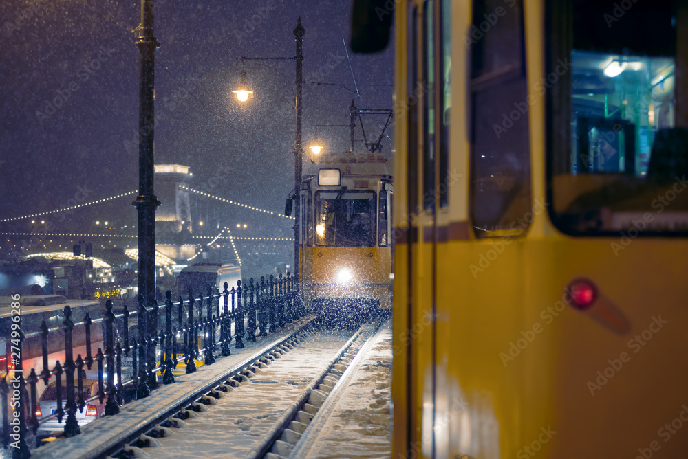 Tramway carriage on snow covered railway track at night