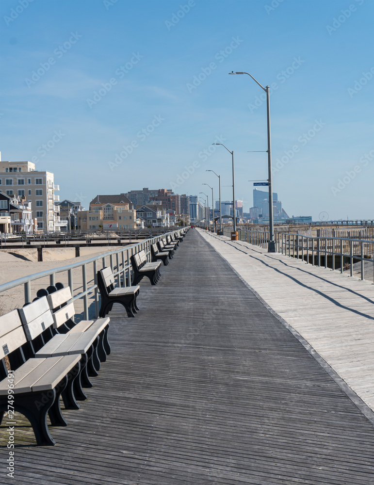 Boardwalk Lined with Benches with Skyline in Background