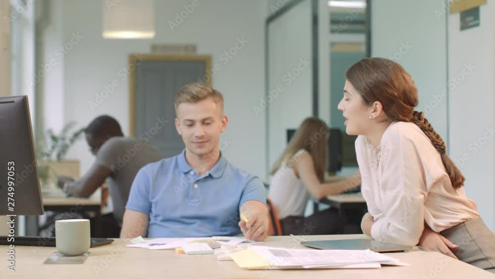 Business team discussing project at coworking. Happy team looking startup charts Business team discussing project at coworking. Happy team looking startup charts