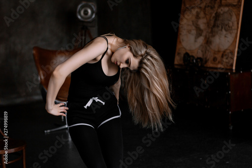 Beautiful slim young female modern jazz contemporary style ballet dancert on a loft studio background photo