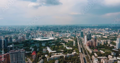 drone hyperlapse: stadium in a green city, a terrible sky and the sun's rays. Kyiv, Ukraine  - Cityscape Aerial Flight photo