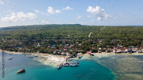 Fototapeta Naklejka Na Ścianę i Meble -  Beautiful aerial view from the beachside village near the jetty with nice sky