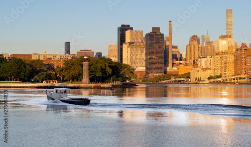 Canvas Print Fishing Poat Passes Roosevelt Island Lighthouse In East River New York