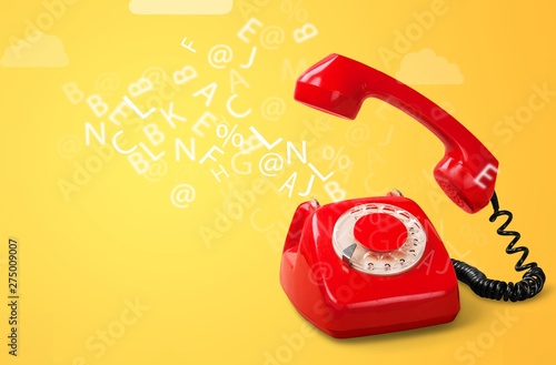 Old retro red telephone on pastel background