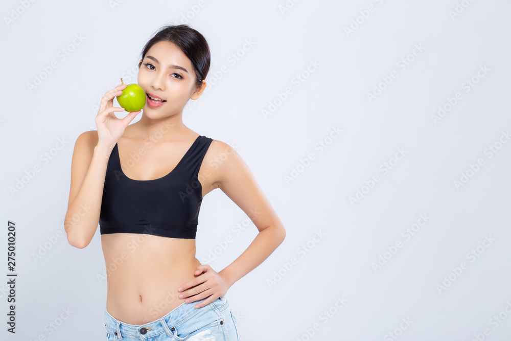 Portrait asian woman smiling holding and eating green apple fruit and beautiful body diet with fit isolated on white background, girl weight slim with cellulite, health and wellness concept. Portrait asian woman smiling holding and eating green apple fruit and beautiful body diet with fit isolated on white background, girl weight slim with cellulite, health and wellness concept.