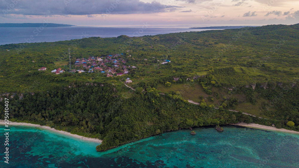 Beautiful aerial view of village beside blue ocean with nice sunset sky