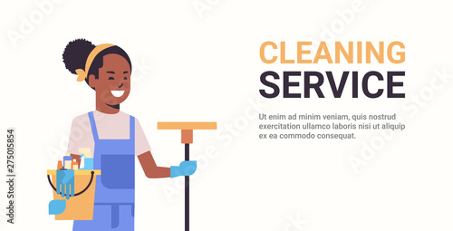 woman janitor holding bucket with tools and mop cleaning service concept smiling african american female cleaner portrait horizontal copy space flat