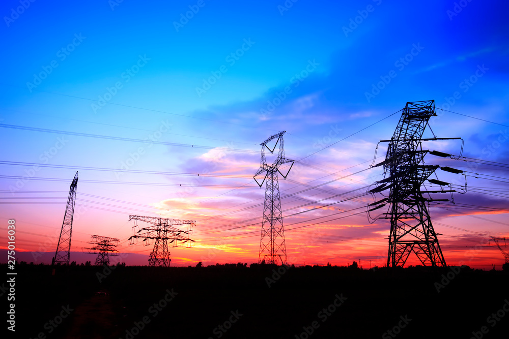 Fototapeta premium In the evening, the silhouette of high voltage towers