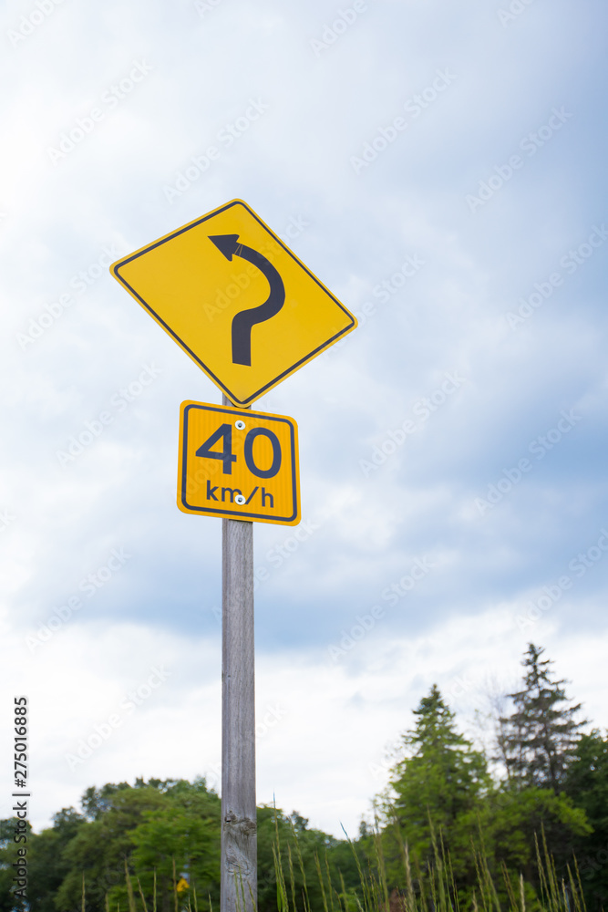 Road Signs Showing Speed Limit 40 km/h And Turn Ahead