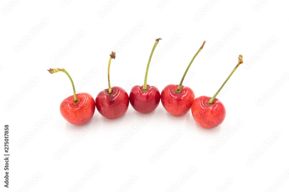 5 fresh cherries neatly arranged in a row on a white background 5 fresh cherries neatly arranged in a row on a white background