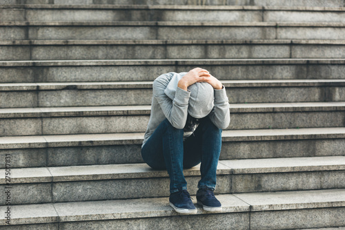 Upset woman sitting alone in city stairs
