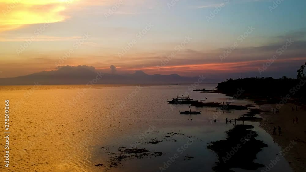 Aerial of epic Sunset and silhouettes of boats from Paliton Beach, Siquijor, Cebu, Philippines Aerial of epic Sunset and silhouettes of boats from Paliton Beach, Siquijor, Cebu, Philippines