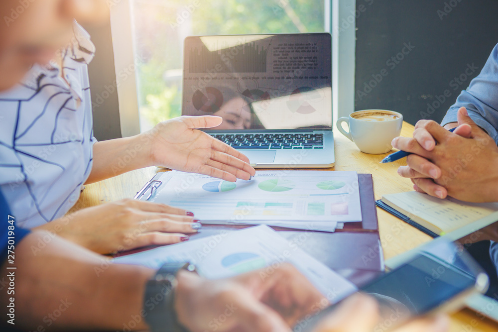 Business people meeting to discuss the situation on the market. Analyzing marketing data for start up new business project. Business people meeting to discuss the situation on the market. Analyzing marketing data for start up new business project.