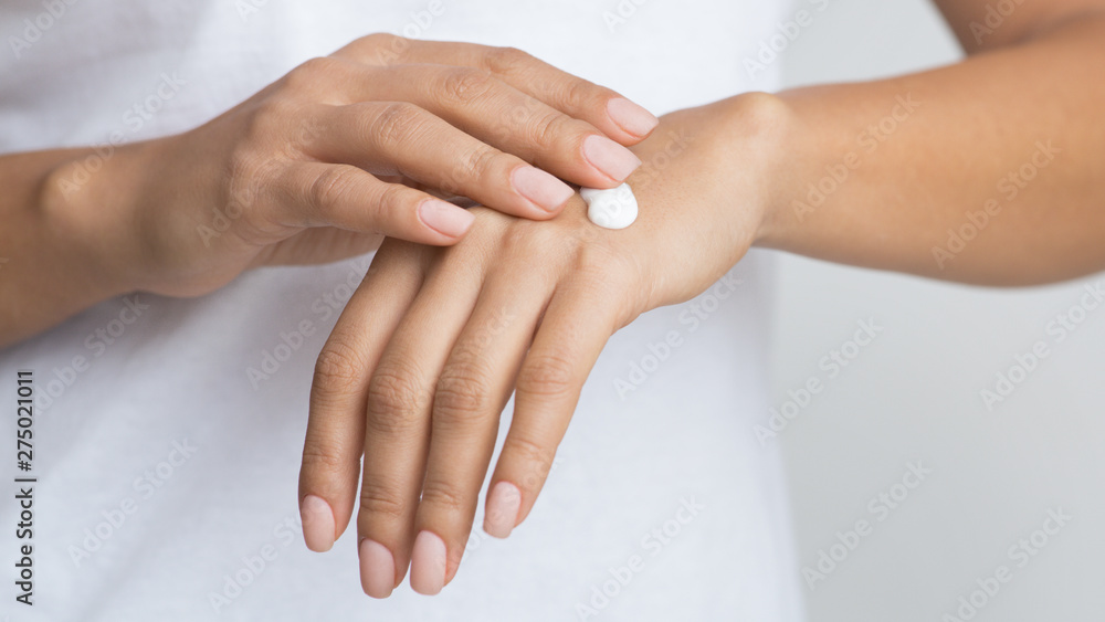 Young Skin. Woman Applying Moisturizing Hand Cream Young Skin. Woman Applying Moisturizing Hand Cream