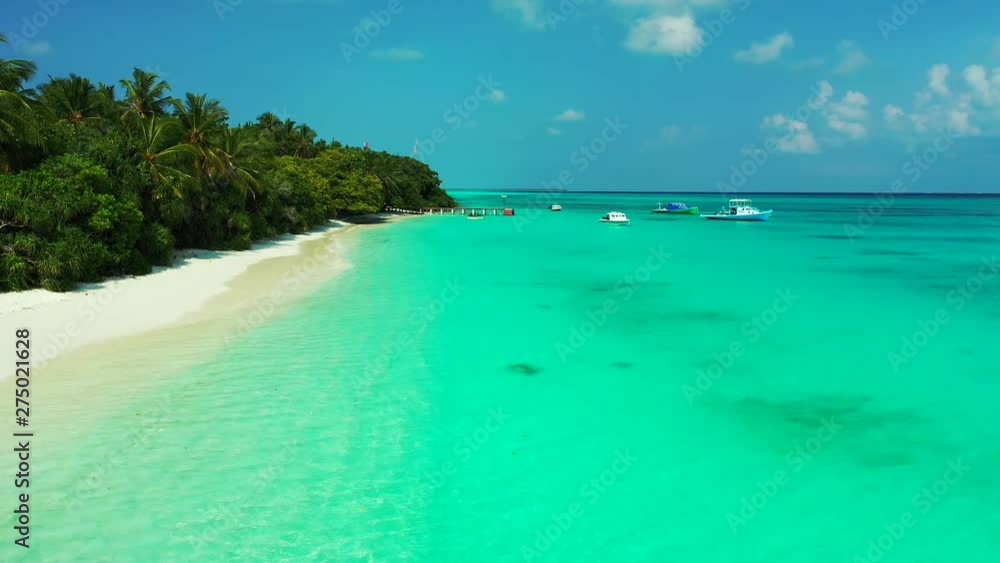 Perfect Wild Sandy Maldives Beach With Turquoise crystal clear sea water and floating tour boats, aerial drone dolly in shot Perfect Wild Sandy Maldives Beach With Turquoise crystal clear sea water and floating tour boats, aerial drone dolly in shot