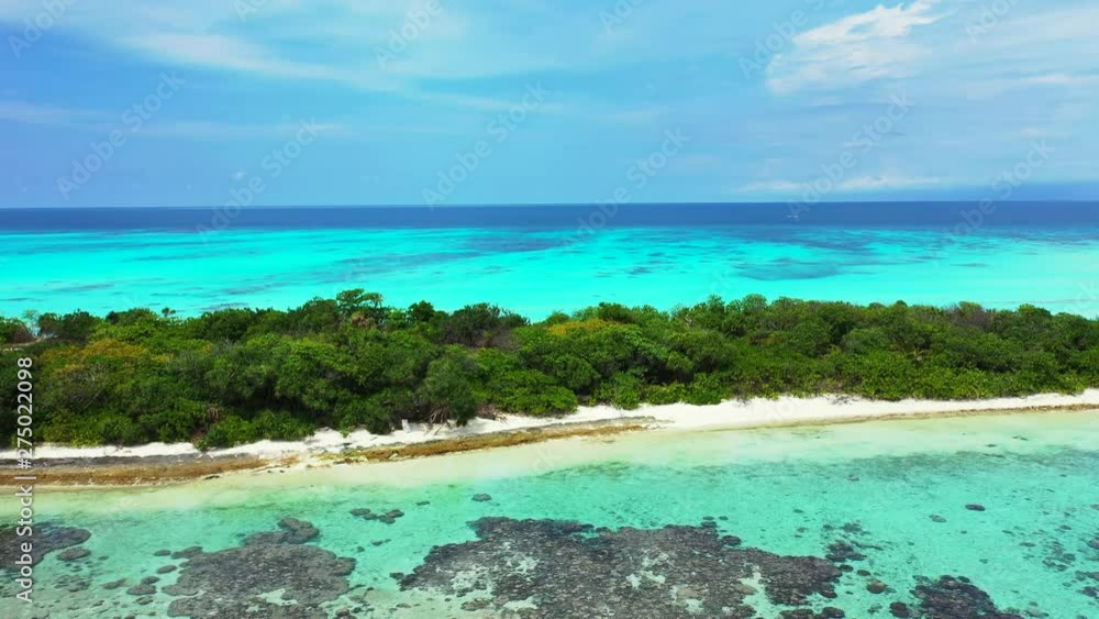 Aerial drone dolly in shot of the Deserted Island Innafushi in Baa Atoll, Maldives, preserved nature, crystal clear water and rich marine life Aerial drone dolly in shot of the Deserted Island Innafushi in Baa Atoll, Maldives, preserved nature, crystal clear water and rich marine life