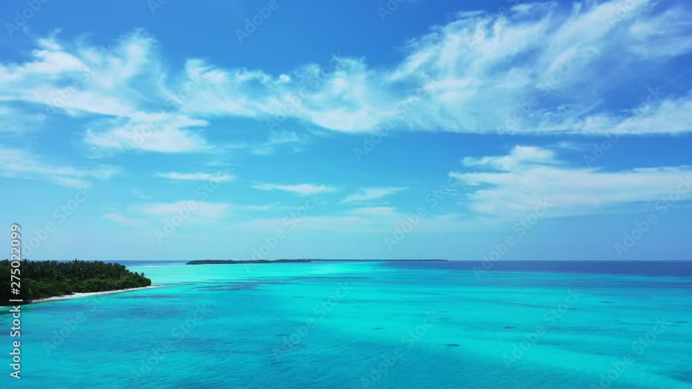 Aitutaki Lagoon, Isolated Islands Called Motus in crystal clear water with coral reef, aerial drone panning left shot Aitutaki Lagoon, Isolated Islands Called Motus in crystal clear water with coral reef, aerial drone panning left shot