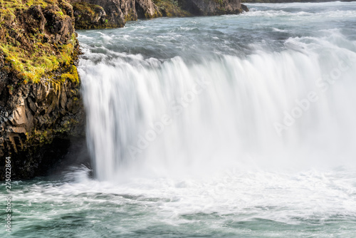 Godafoss, Iceland waterfall closeup view of the gods with long exposure smooth motion of water falling off cliff in summer landscape