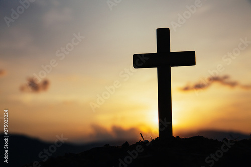 Jesus Christ cross. Easter, resurrection concept. Christian wooden cross on a background with dramatic lighting.