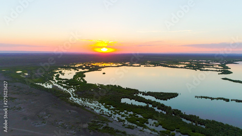 Aerial view over The Ailik Lake during sunset with beautiful colors and reflection from the sun. The Ailik or Aylik lake is a lake in Xinjiang Uighur Autonomous Region of China. 