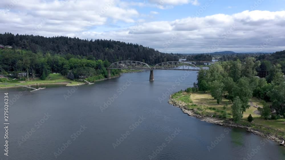 Aerial dolly forward over the willamette river with a train bridge in the background. Aerial dolly forward over the willamette river with a train bridge in the background.