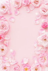 Flowers composition pastel colors. background from  beautiful pale pink roses frame, border on pink  background.Top view.Copy space