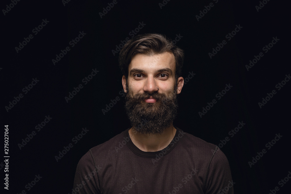 Close up portrait of young man isolated on black studio background. Photoshot of real emotions of male model. Smiling, feeling happy. Facial expression, pure and clear human emotions concept. Close up portrait of young man isolated on black studio background. Photoshot of real emotions of male model. Smiling, feeling happy. Facial expression, pure and clear human emotions concept.