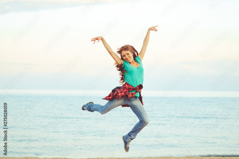 girl jumping by the sea