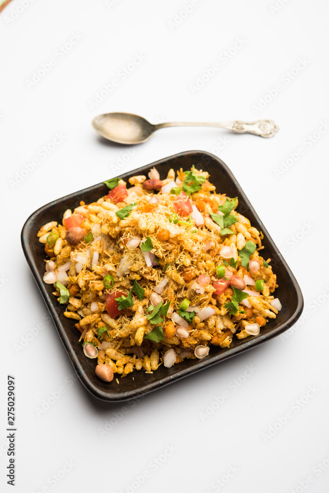Bhelpuri Chaat/chat is a road side tasty food from India, served in a bowl or plate. selective focus Bhelpuri Chaat/chat is a road side tasty food from India, served in a bowl or plate. selective focus
