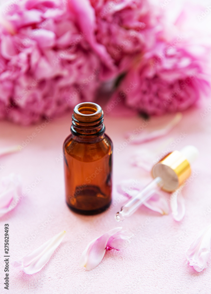 Aromatherapy essentials oils and pink peonies Aromatherapy essentials oils and pink peonies