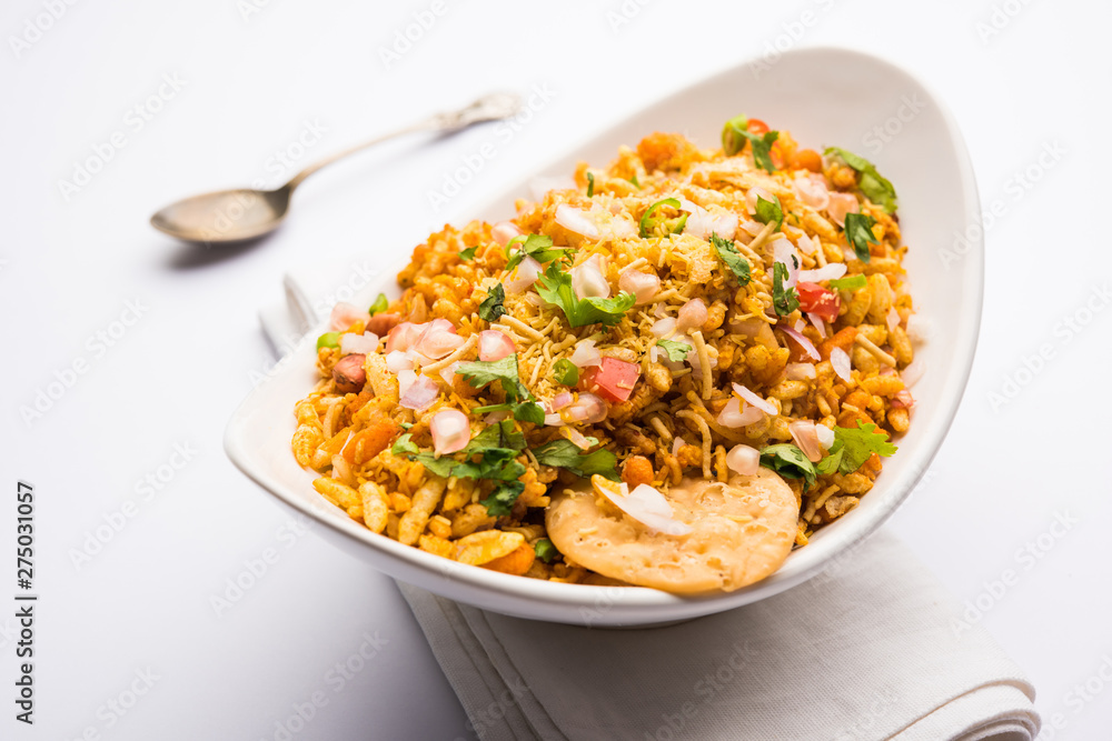 Bhelpuri Chaat/chat is a road side tasty food from India, served in a bowl or plate. selective focus Bhelpuri Chaat/chat is a road side tasty food from India, served in a bowl or plate. selective focus