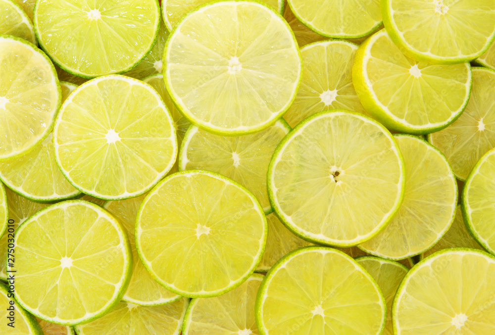 Background of ripe sliced limes Background of ripe sliced limes