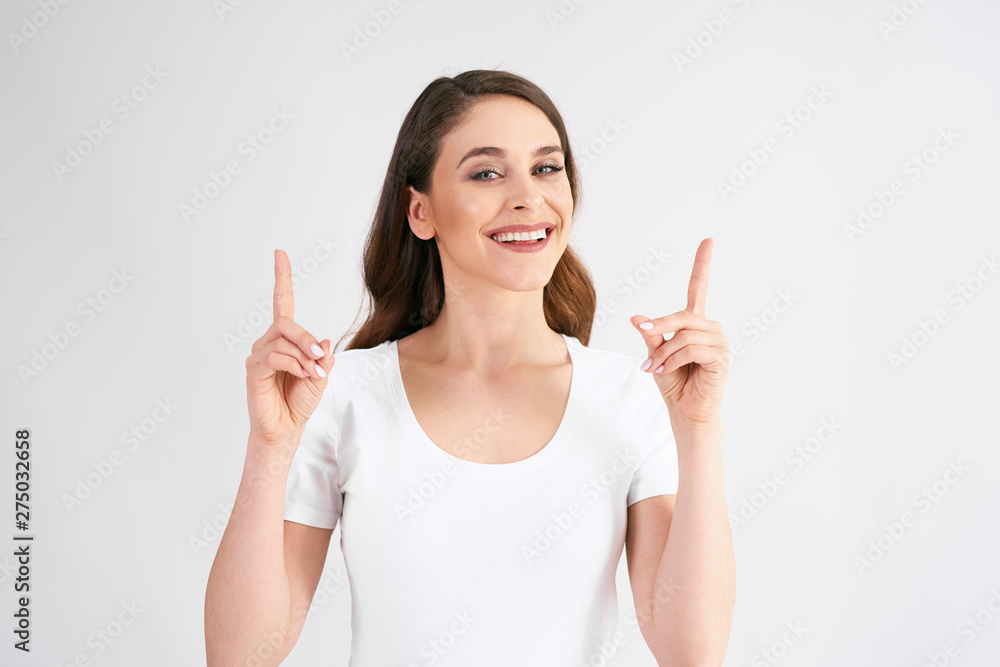 Smiling woman pointing at copy space Smiling woman pointing at copy space