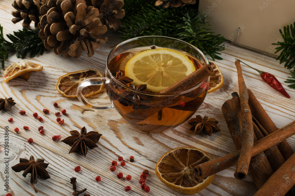 Hot winter drink with spices on festive new year background Hot winter drink with spices on festive new year background