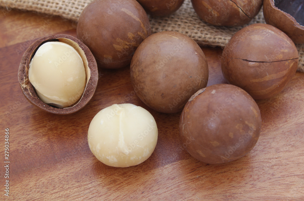 Macadamia nuts on wooden table close up Macadamia nuts on wooden table close up
