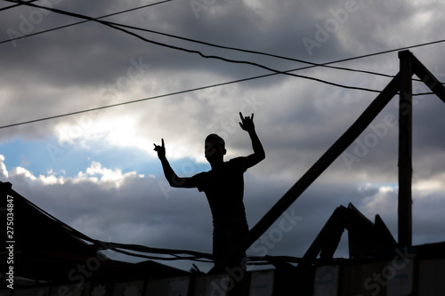 abstract silhouette of a man against the sky with clouds