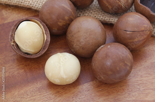 Macadamia nuts on wooden table close up