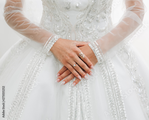 Valokuvatapetti Bride is holding hands with golden rings on her luxury long sleeve dress