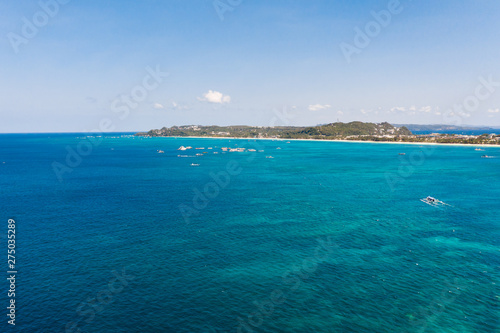 Sulu Sea, view of the island of Boracay, Philippines. Seascape, blue sea and a large densely populated island, aerial view.