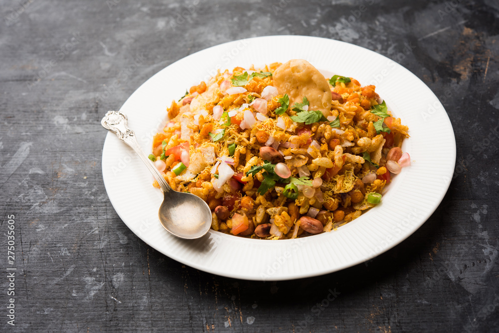 Bhelpuri Chaat/chat is a road side tasty food from India, served in a bowl or plate. selective focus Bhelpuri Chaat/chat is a road side tasty food from India, served in a bowl or plate. selective focus