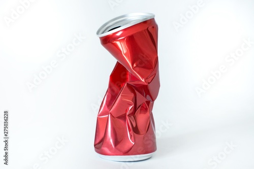 squeezed red soda can on white background