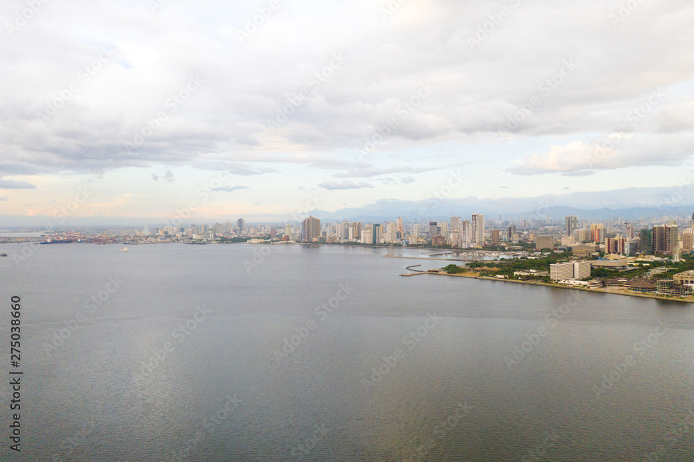 Fototapeta premium Manila city in the morning, view from above. Panorama of a large port city. City with modern buildings and skyscrapers. Manila, the capital of the Philippines. Asian metropolis.