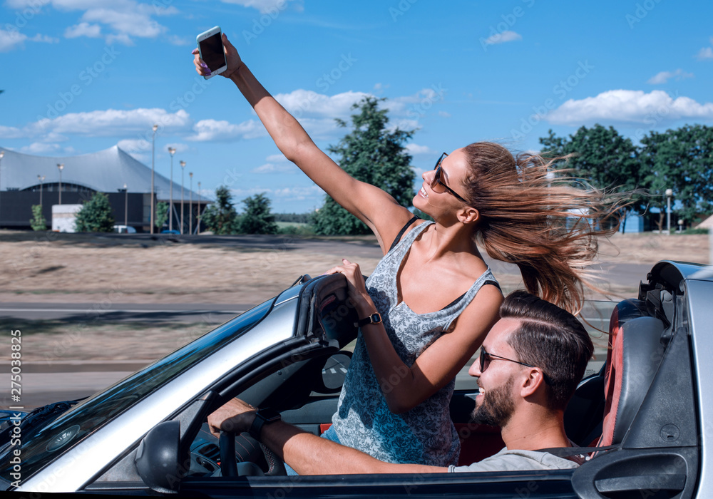 young woman taking a selfie in the car