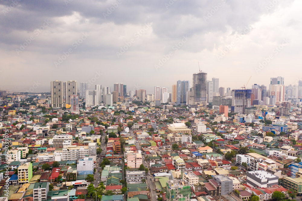 Obraz premium The city of Manila, the capital of the Philippines. Modern metropolis in the morning, top view. New buildings in the city. Panorama of Manila. Skyscrapers and business centers in a big city.