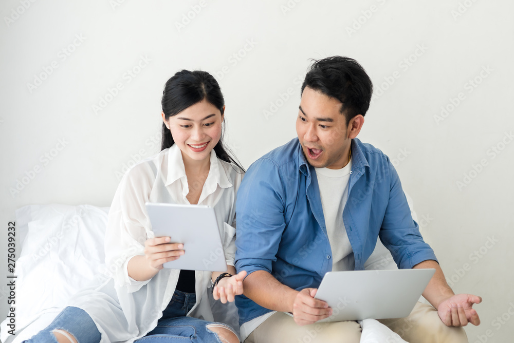 Surprising Asian couple using laptop at home, lifestyle concept. Surprising Asian couple using laptop at home, lifestyle concept.