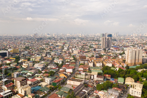 Residential areas and streets of Manila, Philippines, top view. Roofs of houses and roads. Philippine capital. © Tatiana Nurieva