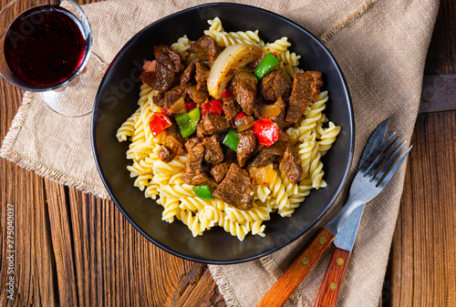 Fussili noodle with klaschise spicy goulash and paprika photo