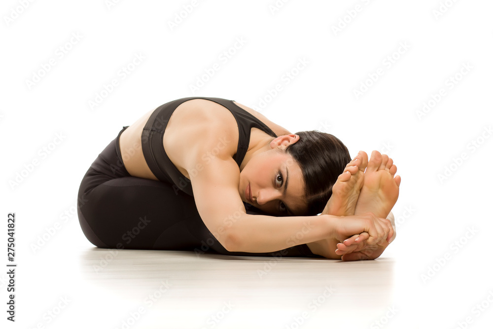Flexible yoga woman doing yoga seated forward bend pose isolated on white background Flexible yoga woman doing yoga seated forward bend pose isolated on white background