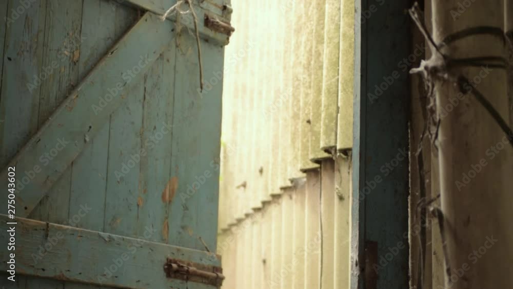Old wooden blue door to the outside slowly closing Old wooden blue door to the outside slowly closing