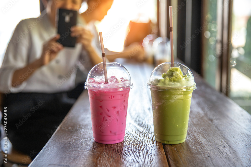 Many types of milk shake in plastic cup with plastic straw put on wood  table , soft sunlight through branch to table in coffee shop. Photos |  Adobe Stock